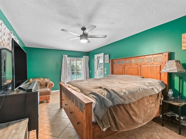 bedroom featuring light tile patterned flooring, ceiling fan, and a textured ceiling