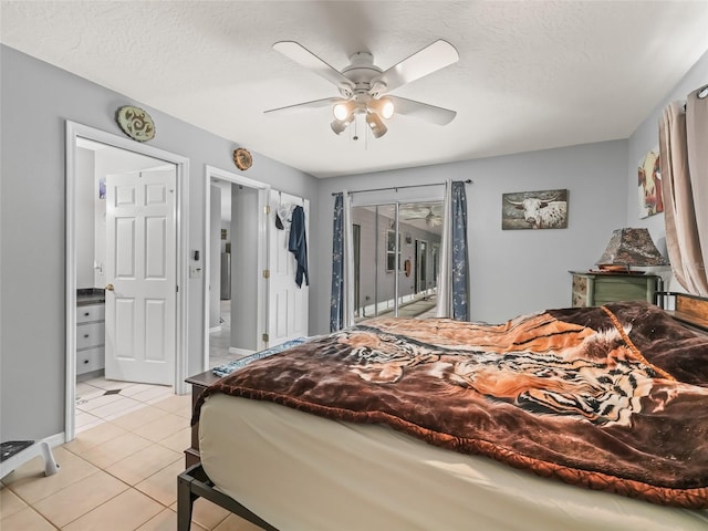 bedroom featuring access to exterior, light tile patterned floors, a ceiling fan, connected bathroom, and a textured ceiling