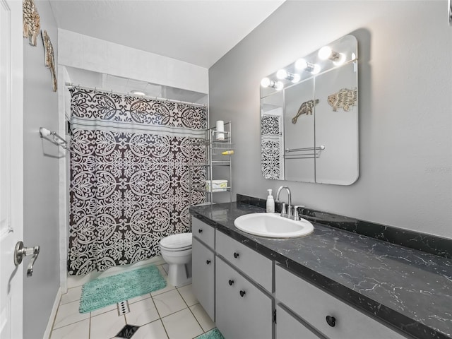 bathroom with tile patterned flooring, a shower with curtain, vanity, and toilet