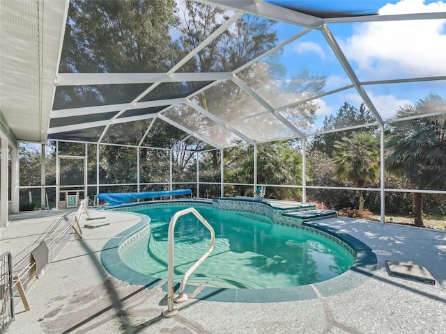 view of swimming pool featuring a patio area, a lanai, and a covered pool