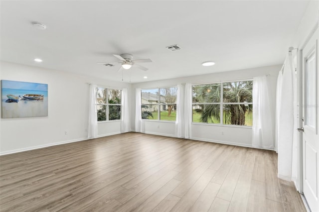 interior space with light wood finished floors, recessed lighting, visible vents, ceiling fan, and baseboards