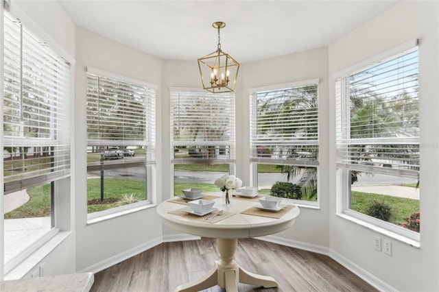 unfurnished sunroom featuring a chandelier