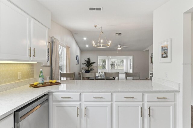 kitchen featuring light stone countertops, visible vents, white cabinetry, and stainless steel dishwasher