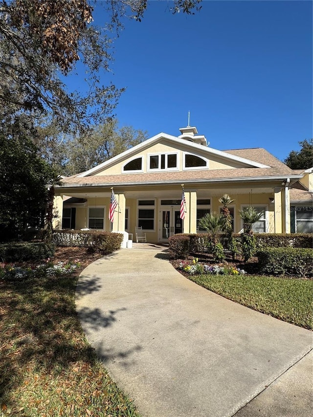 view of front of home with a porch and stucco siding