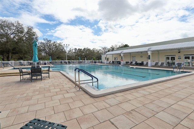 community pool featuring a patio and fence