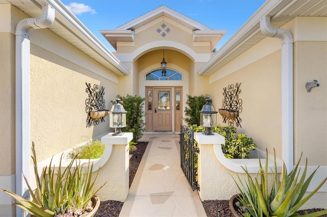 entrance to property featuring stucco siding