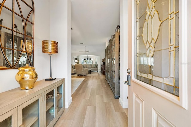 entrance foyer featuring light wood-style flooring and baseboards