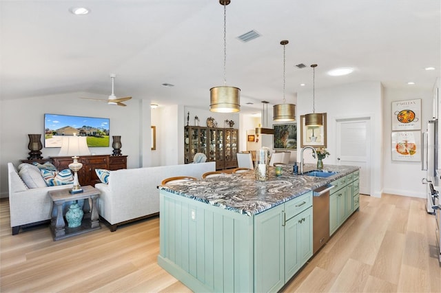 kitchen featuring light wood-style floors, visible vents, stainless steel dishwasher, and a sink