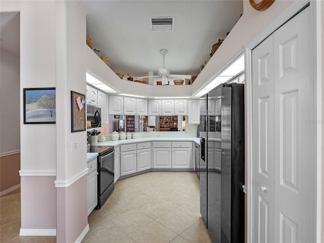 kitchen featuring light tile patterned floors, visible vents, black electric range, fridge with ice dispenser, and light countertops