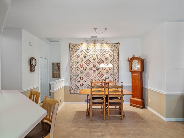 dining space with light tile patterned floors and baseboards