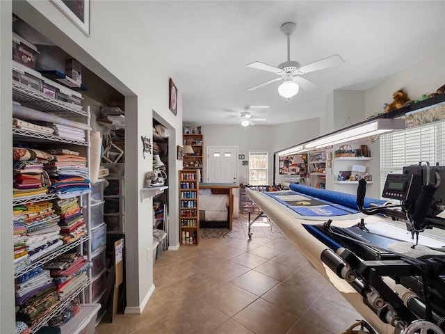 rec room featuring a ceiling fan, tile patterned flooring, and a healthy amount of sunlight