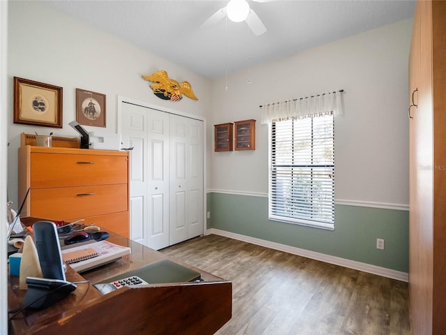 office area with baseboards, a ceiling fan, and wood finished floors