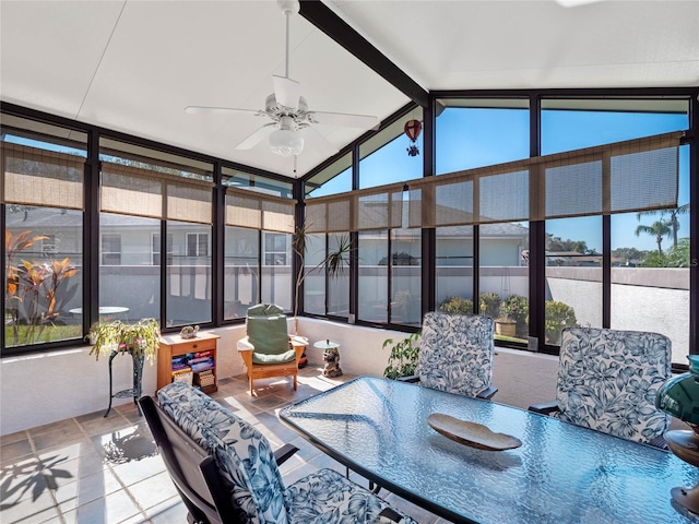 sunroom / solarium featuring lofted ceiling with beams and ceiling fan