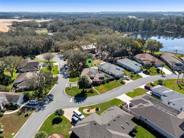 aerial view with a residential view, a water view, and a forest view