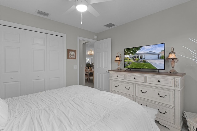 bedroom with a closet, visible vents, and ceiling fan