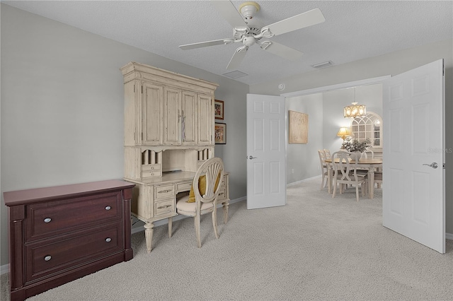 office area with light carpet, a textured ceiling, baseboards, visible vents, and ceiling fan with notable chandelier