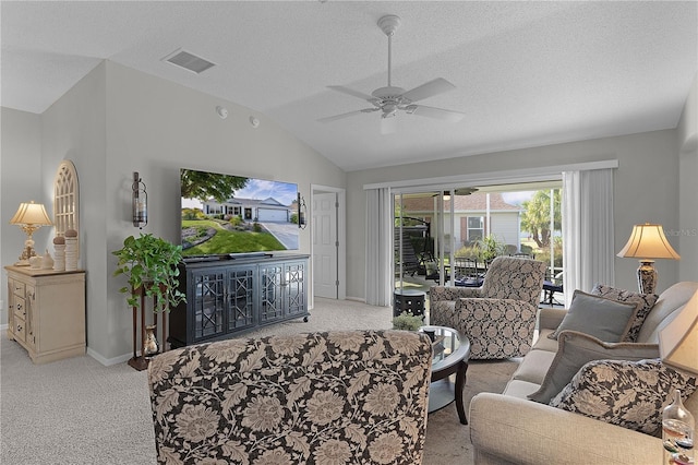 living area with light carpet, vaulted ceiling, visible vents, baseboards, and a ceiling fan