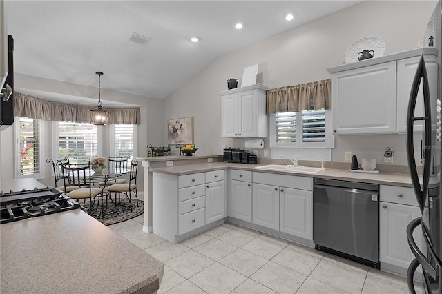 kitchen with vaulted ceiling, stainless steel dishwasher, a sink, white cabinets, and a peninsula
