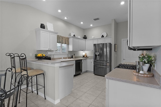 kitchen featuring light tile patterned flooring, stainless steel fridge, dishwasher, a peninsula, and visible vents