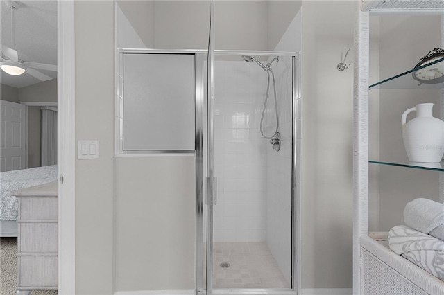 full bathroom with a ceiling fan and a shower stall
