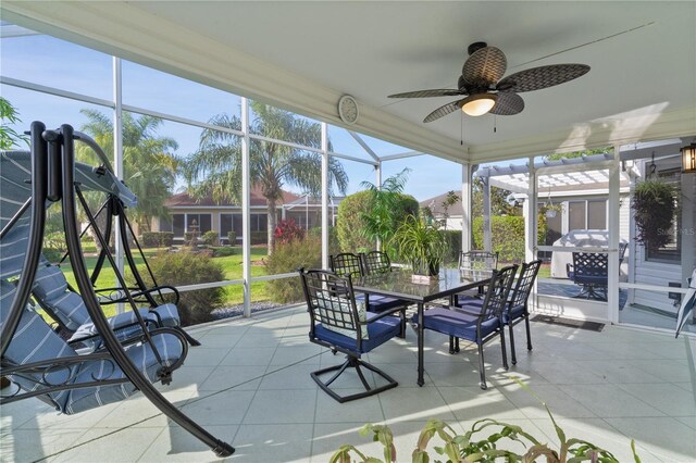 sunroom / solarium featuring outdoor dining space, a wealth of natural light, and a ceiling fan