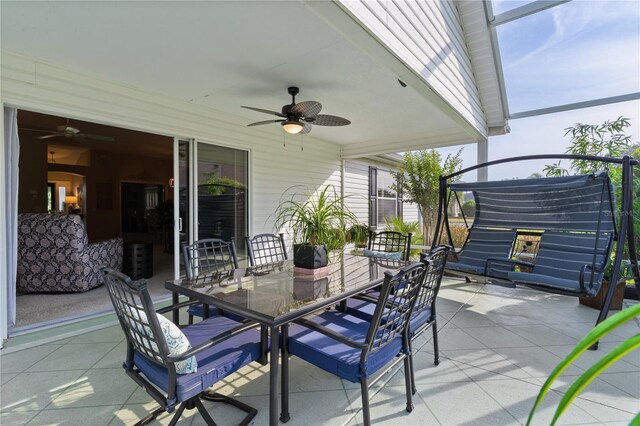 view of patio with outdoor dining space and a ceiling fan