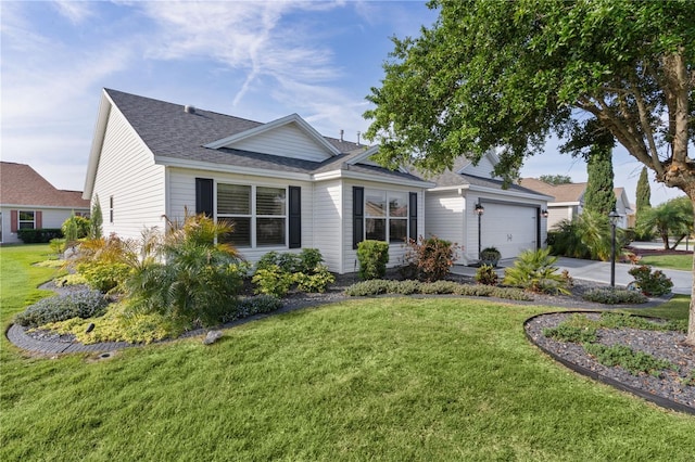 view of front of property featuring concrete driveway, an attached garage, a shingled roof, and a front yard