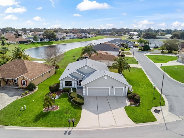 bird's eye view featuring a water view and a residential view