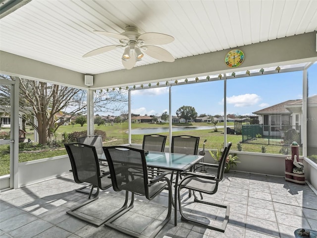 sunroom / solarium featuring ceiling fan