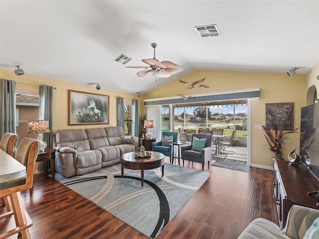 living area featuring dark wood-style floors, visible vents, and vaulted ceiling