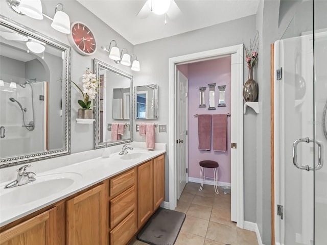 full bathroom with double vanity, a stall shower, a sink, and tile patterned floors