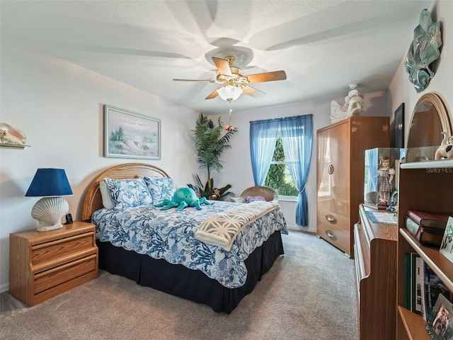 bedroom featuring a ceiling fan and light carpet