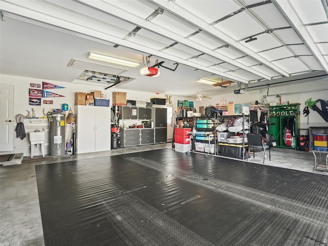 garage with electric water heater and a garage door opener