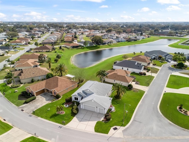 birds eye view of property with a water view and a residential view