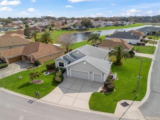 bird's eye view featuring a residential view and a water view