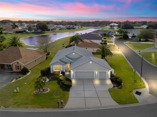 birds eye view of property with a water view and a residential view