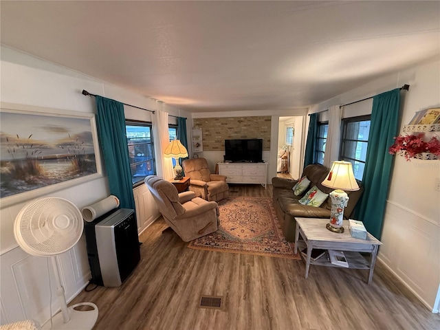 living room with visible vents, plenty of natural light, and wood finished floors