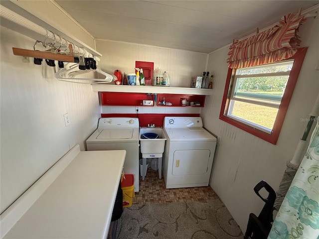 laundry area with washing machine and dryer, laundry area, a sink, and tile patterned floors