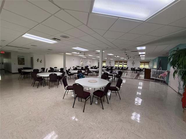 dining area with a paneled ceiling and visible vents