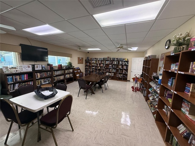 dining room featuring ceiling fan, visible vents, and a drop ceiling