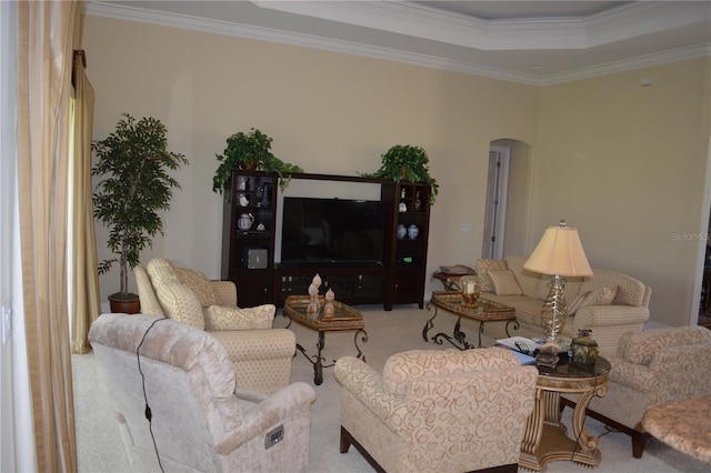 living area featuring arched walkways, ornamental molding, and carpet flooring