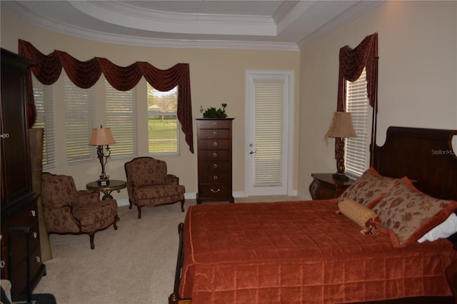 bedroom featuring a tray ceiling, carpet, and ornamental molding