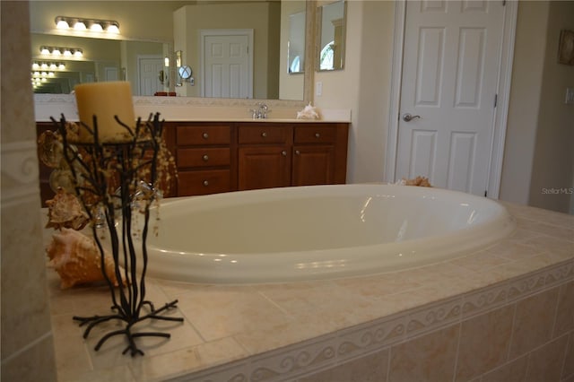 full bathroom with vanity and a garden tub
