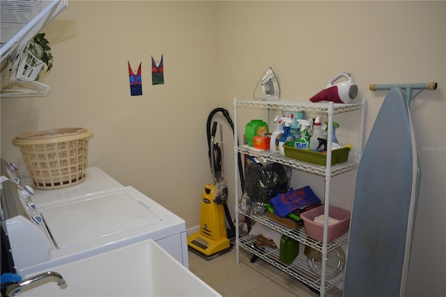 laundry room with washer and clothes dryer, laundry area, and tile patterned floors