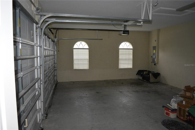 garage with electric panel and a garage door opener