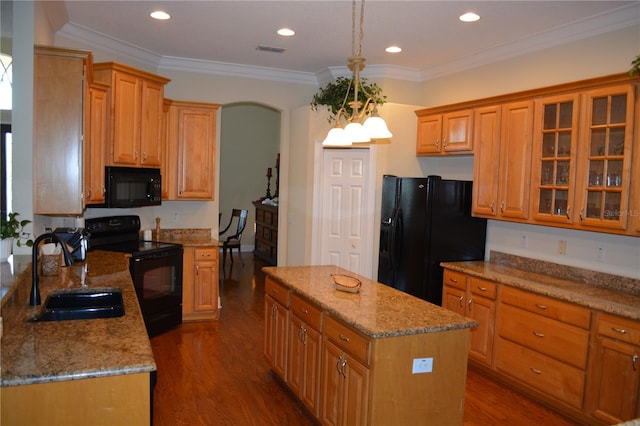 kitchen with a center island, light stone countertops, dark wood finished floors, black appliances, and a sink