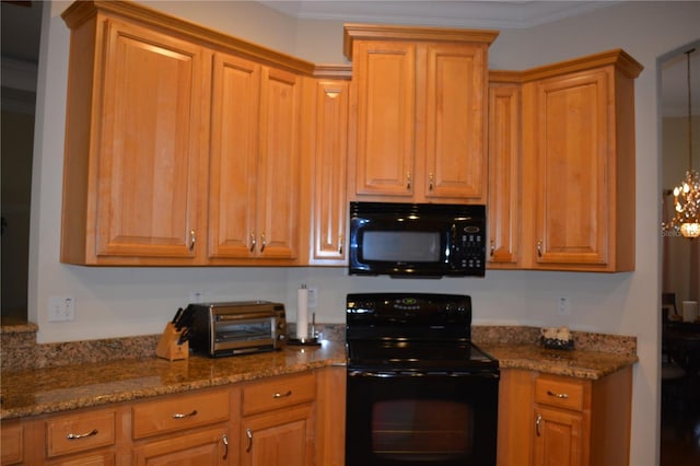 kitchen featuring a toaster, stone counters, black appliances, and crown molding