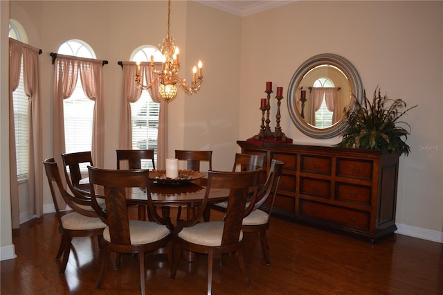 dining room with baseboards, wood finished floors, a chandelier, and crown molding
