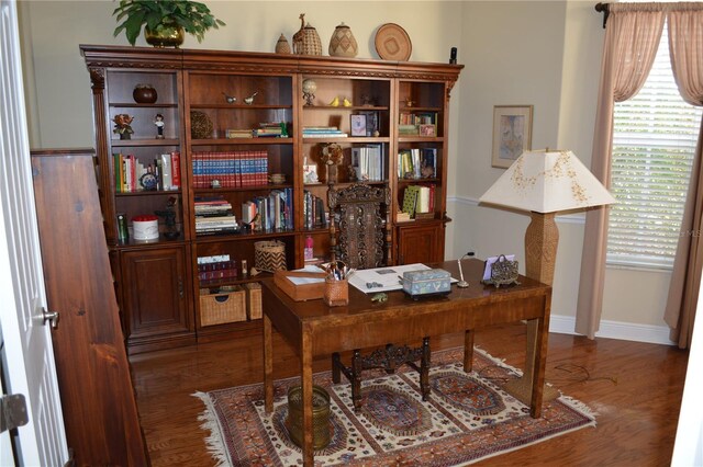 office space with baseboards and wood finished floors
