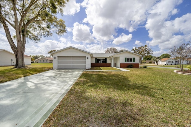 single story home featuring an attached garage, driveway, a front lawn, and brick siding